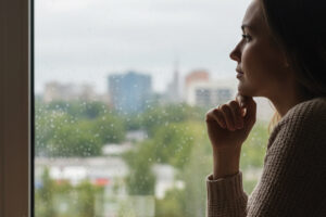 Woman looking out window