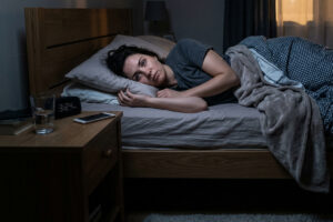WOMAN laying in bed awake in the dark because she can't sleep 701000